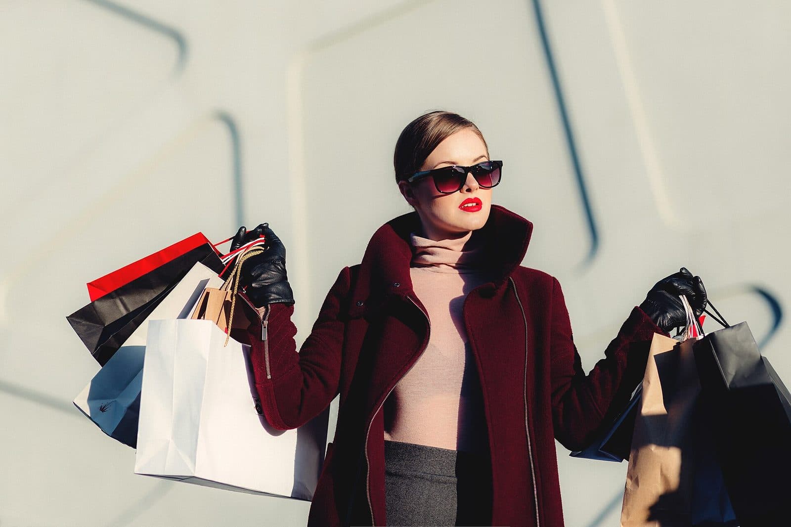 A shopper holding several shopping bags
